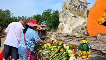 Giant seated Buddha beside a canal in Bangkok